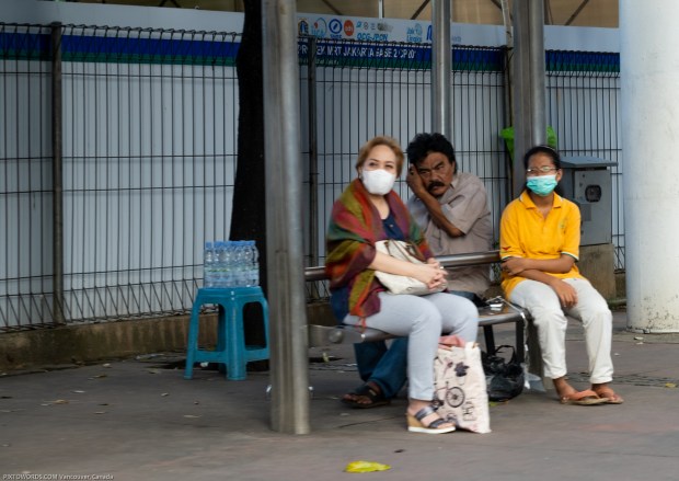 Three at a Bus Stop, Jakarta, Java, Indonesia